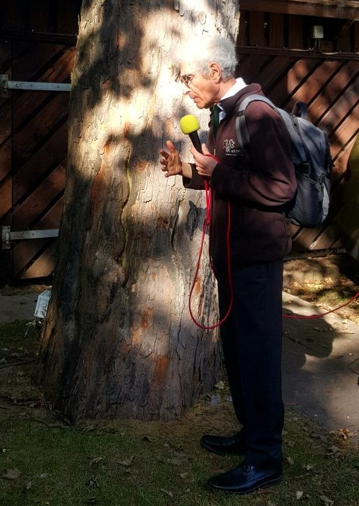 Dr. David Lonsdale presenting next to a tree